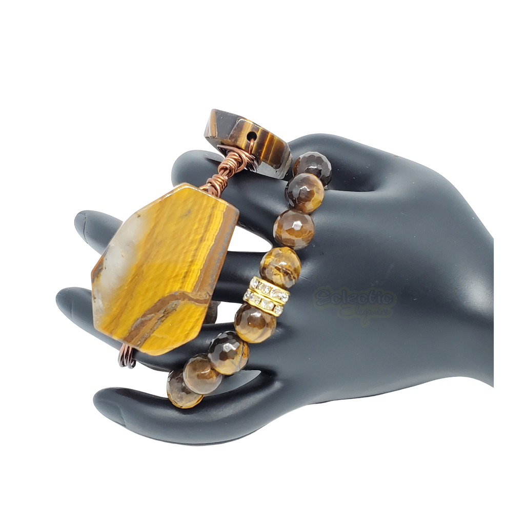 A 2 piece set. One wrapped wire bangle with 3 tigers eye focals. In addition there is a beaeded tigers eye stretch bracelet with CZ crystal accent beads